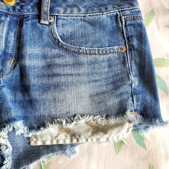 American Eagle High Waist Cut-Off Denim Shorts with Silver Glitter Star Pockets - Picture 5 of 9